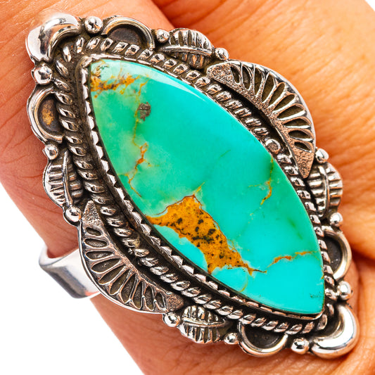 Turquoise oval cabochon ring with ornate sterling-silver bezel and patterned band