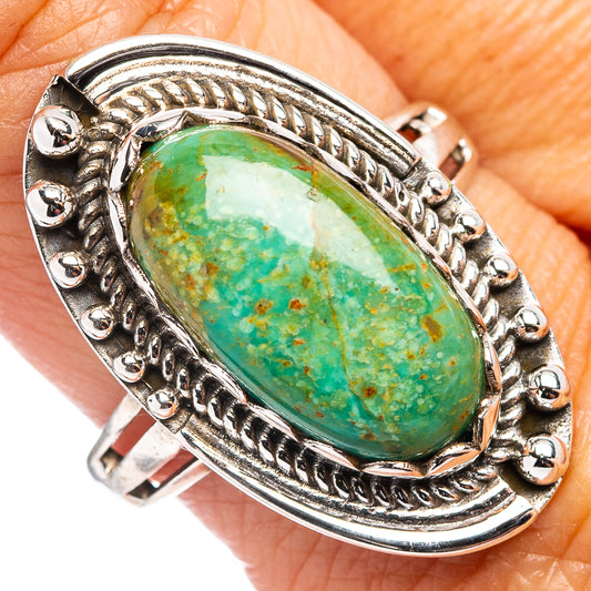 Turquoise oval cabochon silver ring with ornate rope-edge setting and bezel