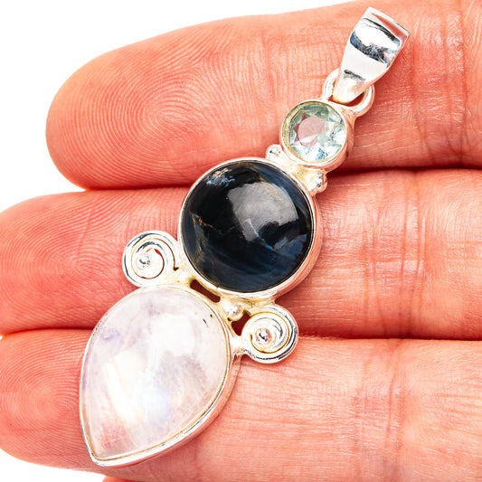 Sterling silver pendant with dark oval gemstone, moonstone oval, and small top bail