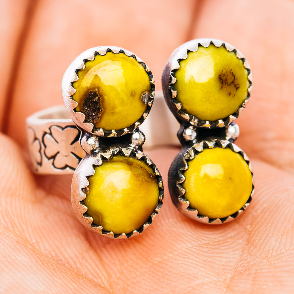 Sterling silver ring with four yellow cabochon stones in scalloped settings