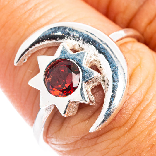 .925 sterling silver ring featuring a red round gemstone with sunburst setting and crescent band