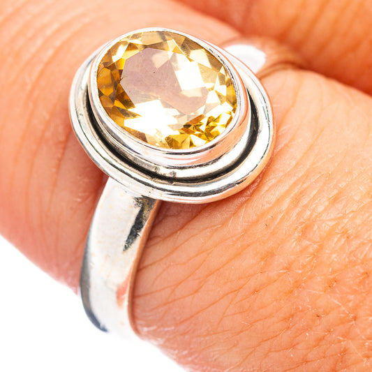 Sterling silver citrine ring with faceted yellow gemstone in raised bezel