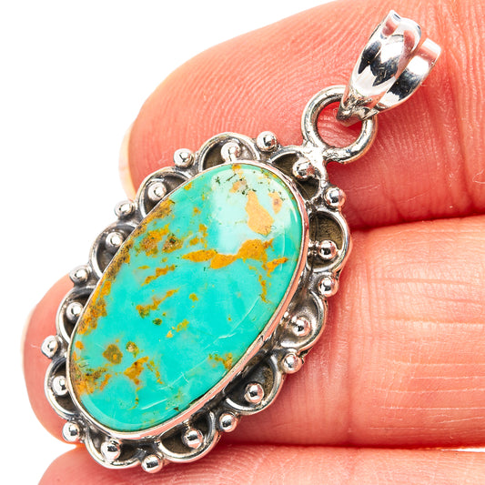 Sterling silver oval turquoise pendant with beaded border and bail, close-up on stone