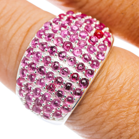 Sterling silver cluster ring with round pink-red gemstones, close-up top view