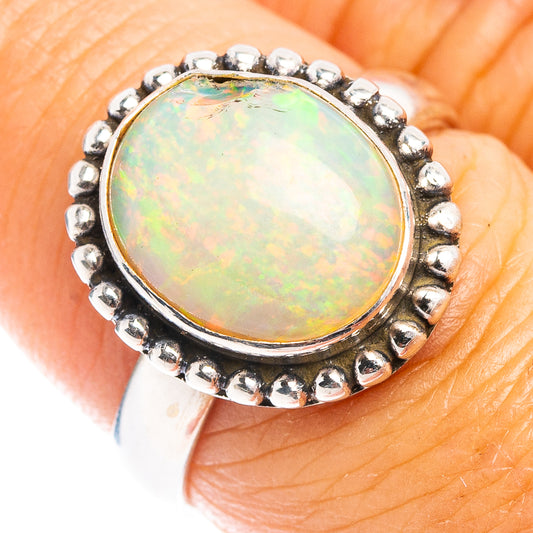 Sterling silver opal cabochon ring, oval iridescent stone in beaded bezel