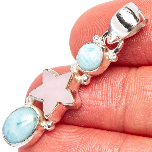 Sterling silver star pendant with pale blue oval stone accents and pink star centerpiece