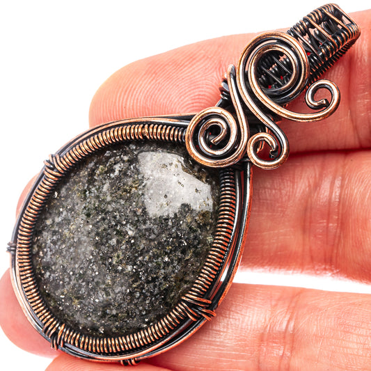Oxidized copper wire-wrapped teardrop pendant with dark druzy stone and spiral swirls