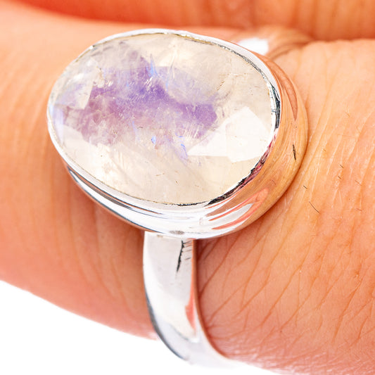 Faceted oval moonstone set in silver ring, cool iridescent color on the stone