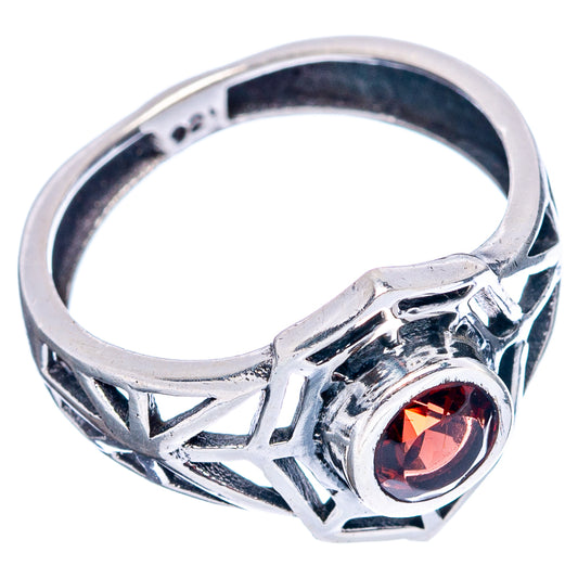 Sterling silver ring with round red garnet and open web-style band