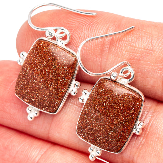 Goldstone earrings with square glitter stones, silver-tone hooks and small dangling charms