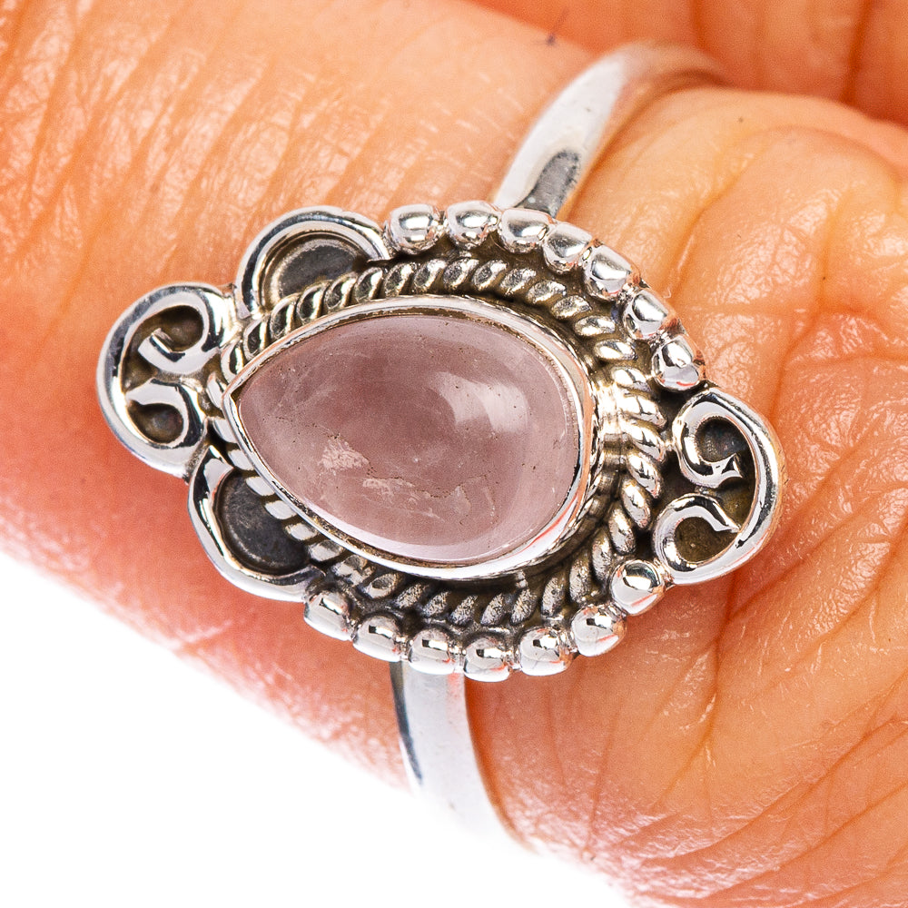 Sterling silver ring with oval rose quartz and ornate halo bezel setting