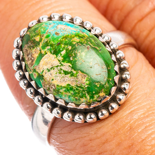 Sterling silver turquoise cabochon ring with green oval stone and beaded halo setting