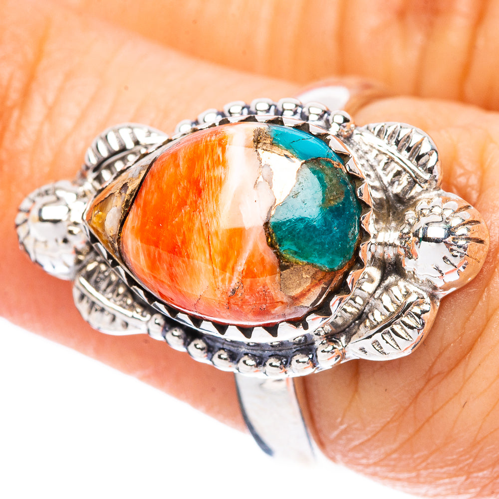 Sterling silver ring with oval orange-red cabochon and small turquoise stone inset