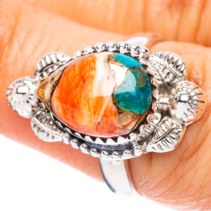Sterling silver ring with oval orange-red cabochon and small turquoise stone inset