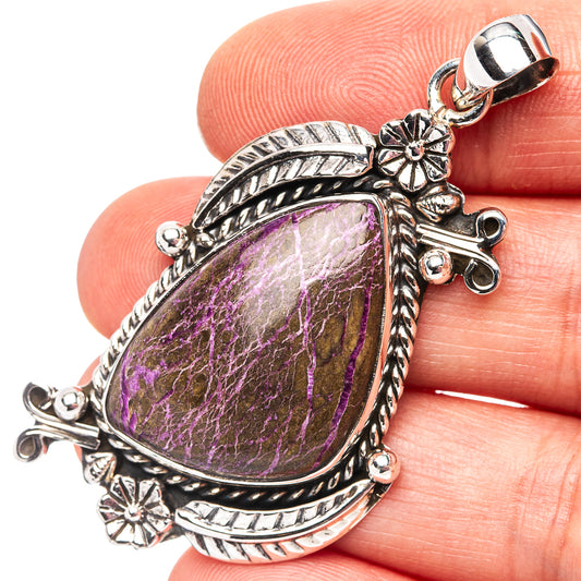 Sterling silver teardrop pendant with ornate frame and purple cabochon