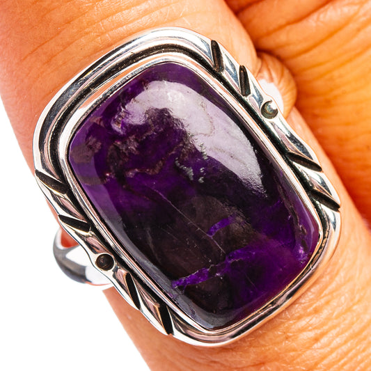 Oval purple sugilite cabochon ring in .925 sterling silver with decorative bezel frame