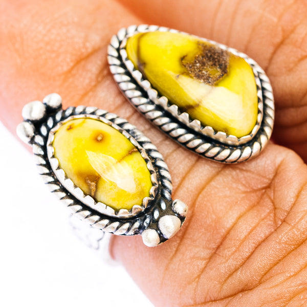 Adjustable sterling silver ring with oval yellow stone and rope-like border