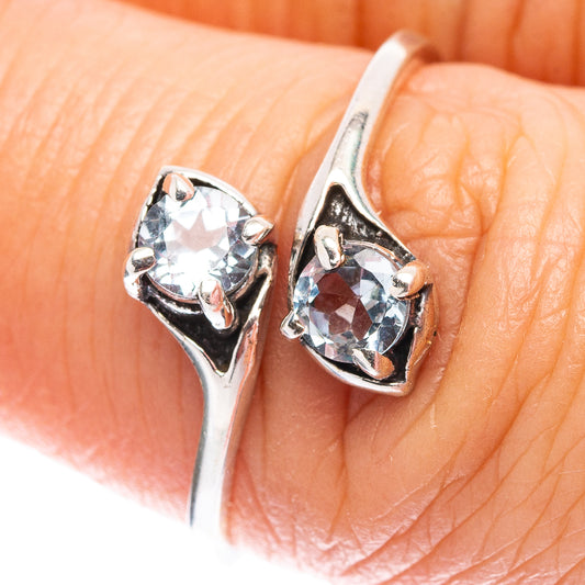 Sterling silver ring with round blue topaz and decorative prongs