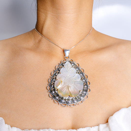 Sterling silver pendant necklace with round mother-of-pearl cabochon in filigree setting