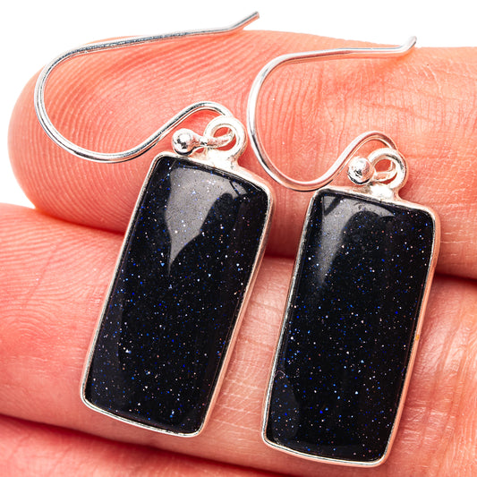 Sterling silver rectangular goldstone drop earrings with dark blue sparkle centers