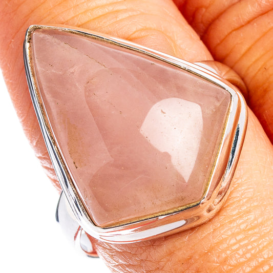 Rose quartz ring close-up: triangular pink stone in silver bezel on hand