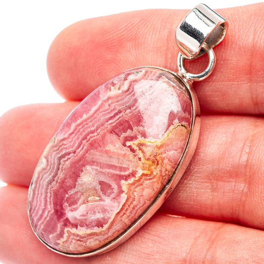 Rhodochrosite oval pendant in .925 sterling silver bezel with hinged bail loop