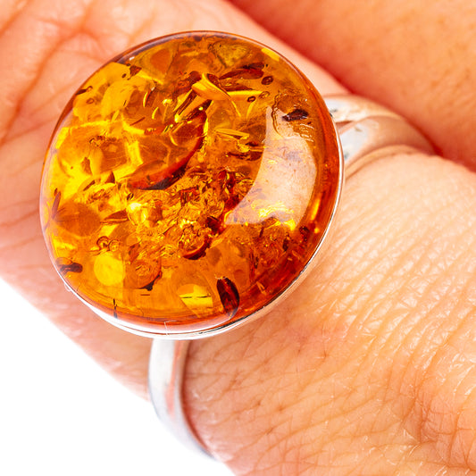 Amber cabochon sterling silver ring with faceted honey-gold oval stone and polished bezel