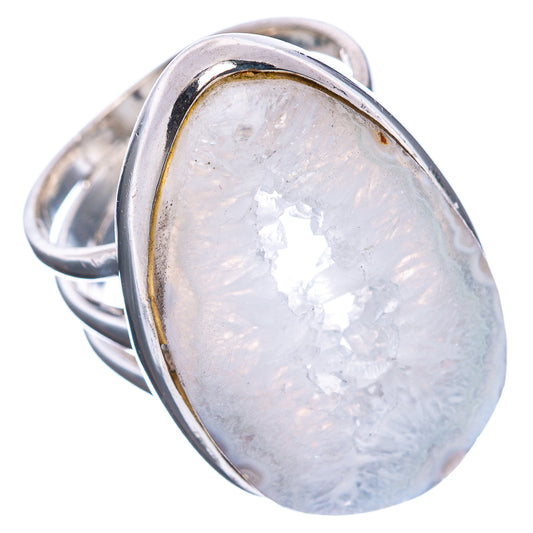 Sterling silver oval geode slice ring with shimmering white crystals, angled view.