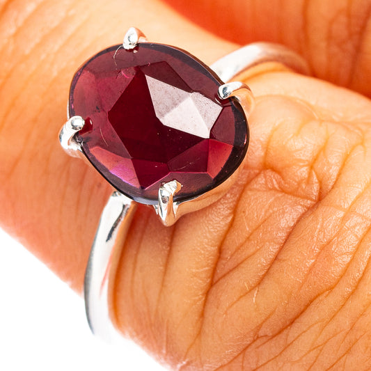 Faceted garnet ring with oval gemstone in prong setting, .925 sterling silver band