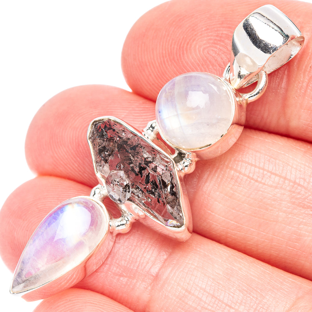 Sterling silver pendant with iridescent round moonstone and faceted dark crystal charm
