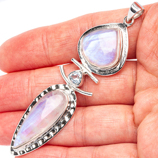 Sterling silver moonstone pendant with teardrop frame and blue topaz accent