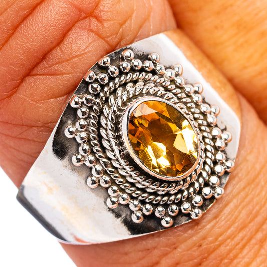 Sterling silver ring with oval citrine gemstone and beaded rope-style border, top view