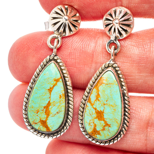Turquoise teardrop dangle earrings with silver sunburst top and oval stone setting