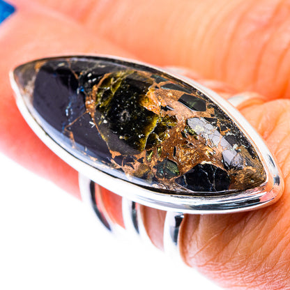 Large oval black onyx ring with gold flecks, sterling silver bezel on finger