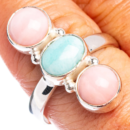 Three-stone sterling silver ring with two pink oval cabochons and blue oval center