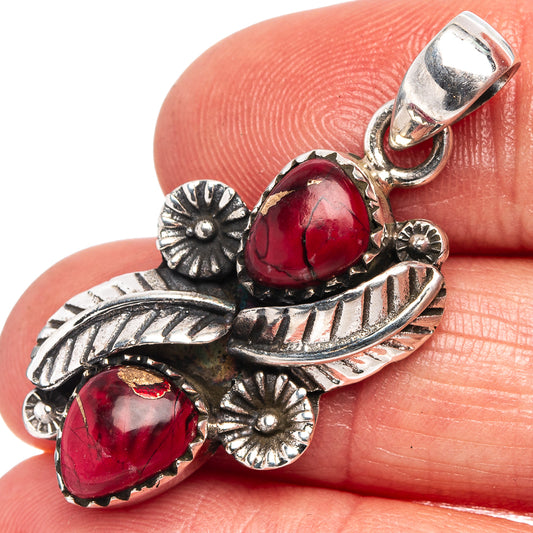 Sterling silver pendant with two red teardrop stones and floral leaf motifs