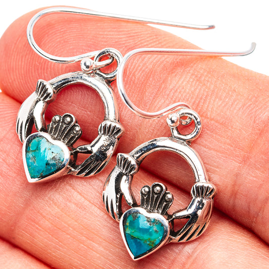 Turquoise heart and sterling silver drop earrings with ornate hand-and-heart design.