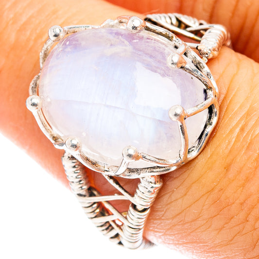 Oval moonstone cabochon ring in polished sterling silver, prong-set with beaded band