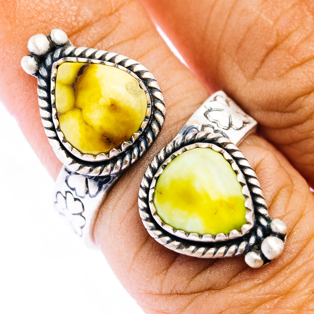 Sterling silver ring with oval yellow teardrop stone, rope border, bead accents