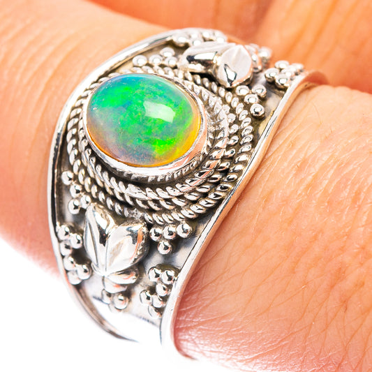 Sterling silver opal ring with oval green opal and ornate engraved bezel