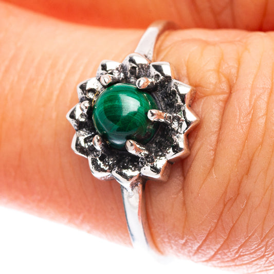 Green malachite cabochon sterling silver ring with spiked flower-like setting on finger
