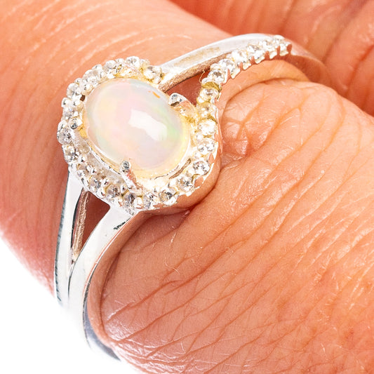 Oval opal-like gemstone ring in .925 sterling silver with cubic zirconia halo