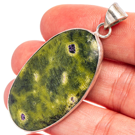 Silver-plated stichtite teardrop pendant, green stone with purple specks.