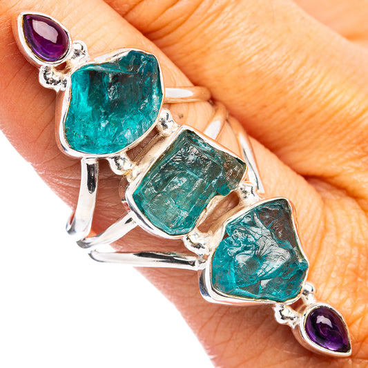 Sterling silver ring with teal emerald-cut and purple amethyst gemstones, open band