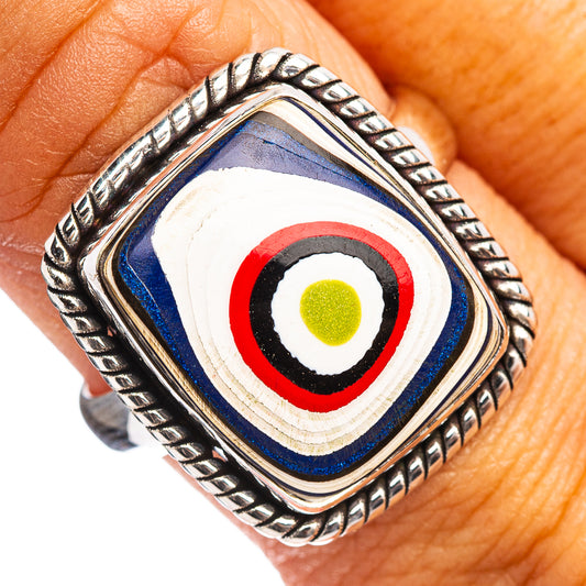 Sterling silver ring on finger, blue inlay with white, red, and green target circle