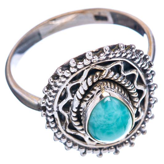 Sterling silver ring side view with oval turquoise stone set in filigree bezel