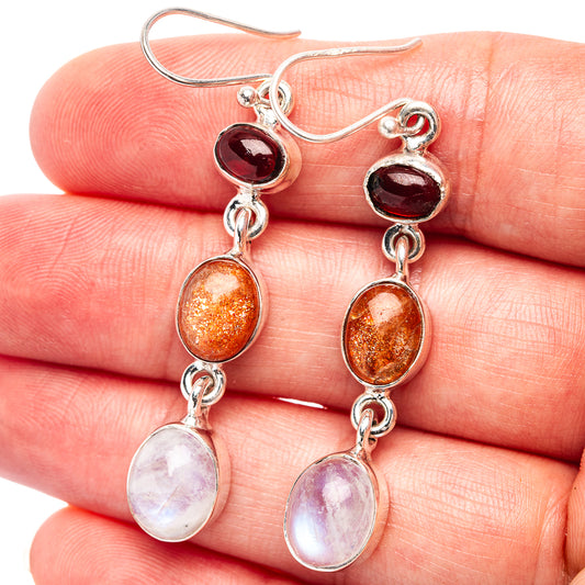 Sterling silver drop earrings with garnet-red, orange, and white moonstone oval stones