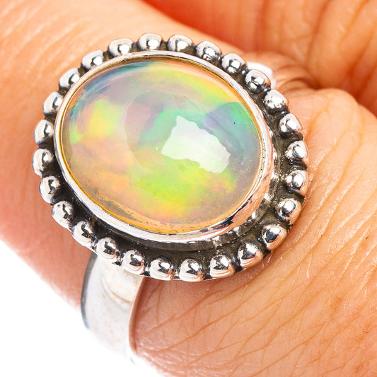 Sterling silver oval opal ring with beaded halo setting