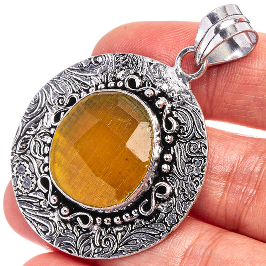 German silver pendant with yellow cabochon and ornate oval filigree setting