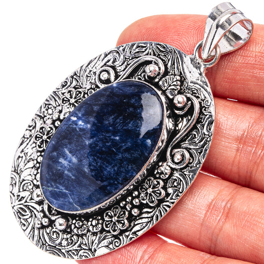 German silver oval sodalite pendant with ornate floral border and top bail